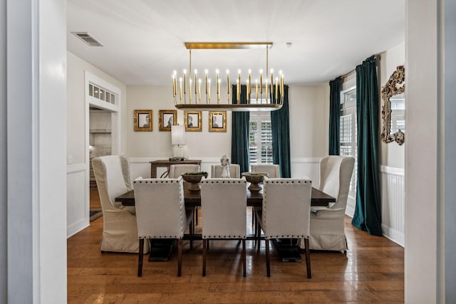 dining space featuring dark hardwood / wood-style flooring and a notable chandelier