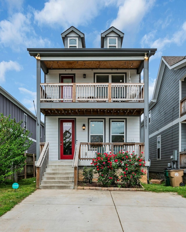 view of front facade featuring covered porch and a balcony