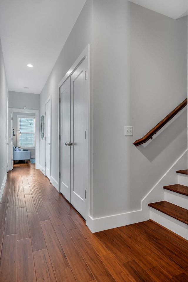 corridor with hardwood / wood-style flooring