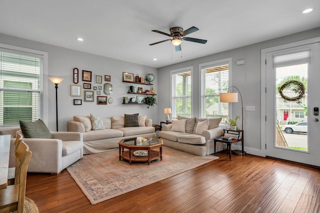 living room featuring hardwood / wood-style floors and ceiling fan