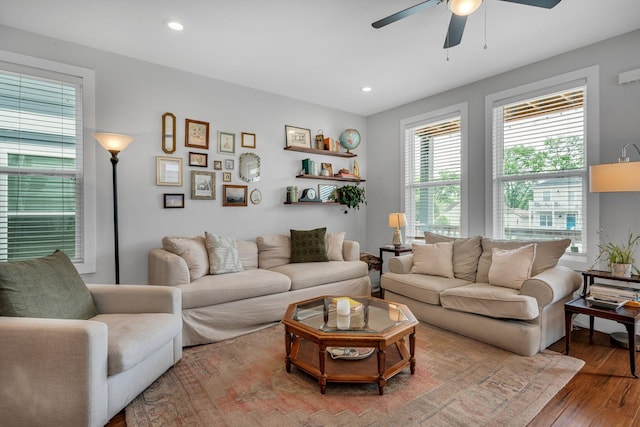 living room featuring ceiling fan and light hardwood / wood-style floors