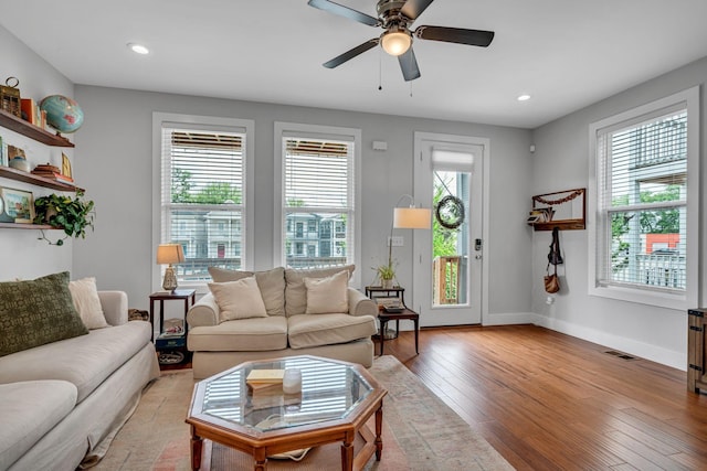 living room featuring ceiling fan and light hardwood / wood-style flooring