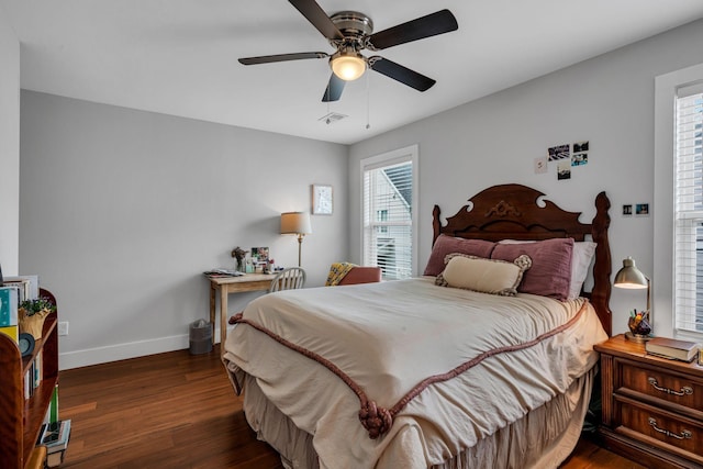 bedroom with ceiling fan and dark wood-type flooring