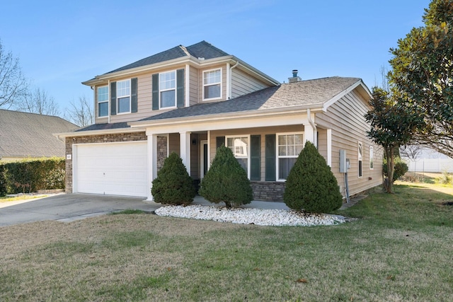 view of front of home with covered porch, a garage, and a front lawn