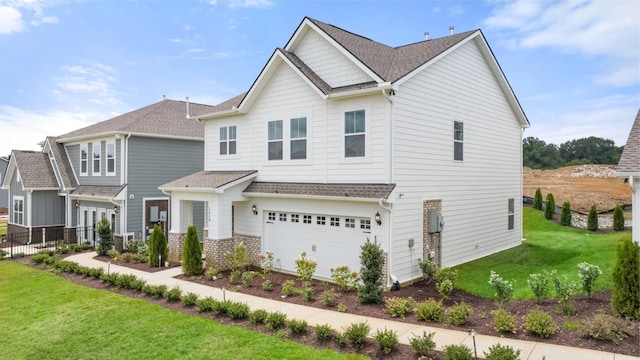 craftsman inspired home with a garage and a front lawn