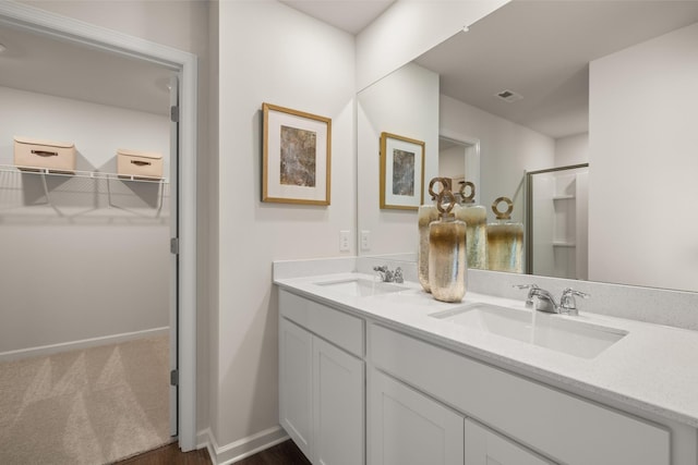 bathroom with vanity and a shower with door