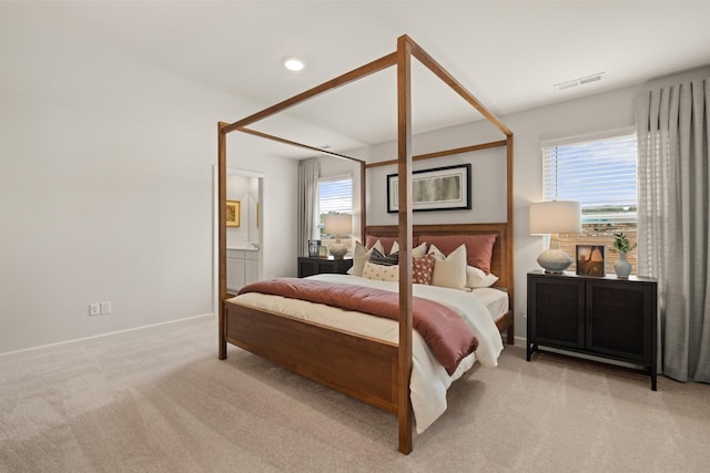 carpeted bedroom with ensuite bathroom