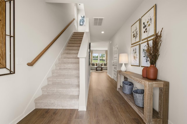 stairs featuring hardwood / wood-style flooring