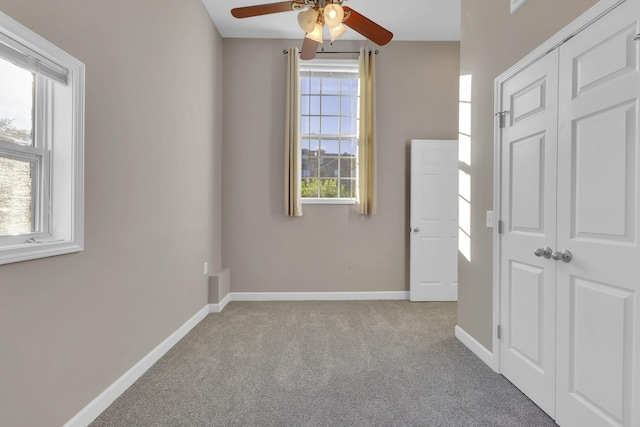 unfurnished room featuring light carpet and ceiling fan