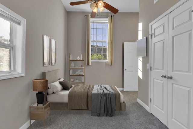 bedroom featuring ceiling fan, a closet, and carpet