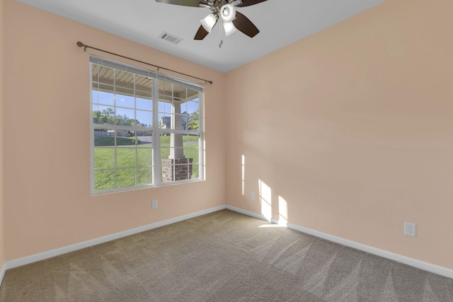 unfurnished room with ceiling fan, a healthy amount of sunlight, and light carpet