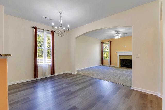 interior space featuring hardwood / wood-style floors and ceiling fan with notable chandelier