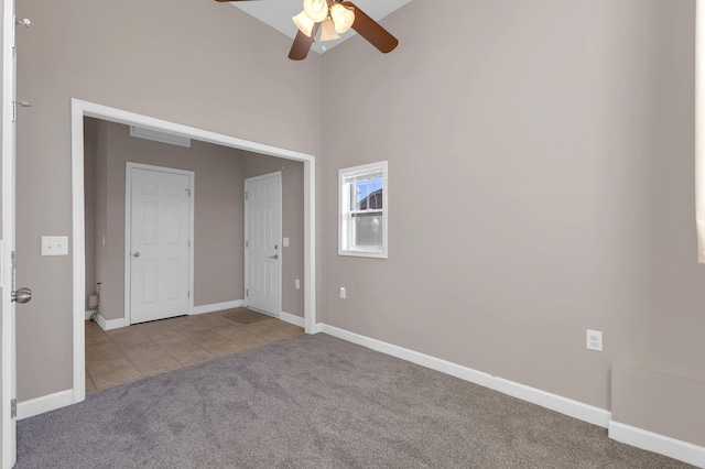 spare room featuring ceiling fan and light carpet