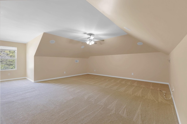 bonus room featuring ceiling fan, light colored carpet, and vaulted ceiling