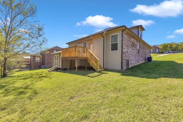 back of house featuring a yard, a wooden deck, and central air condition unit