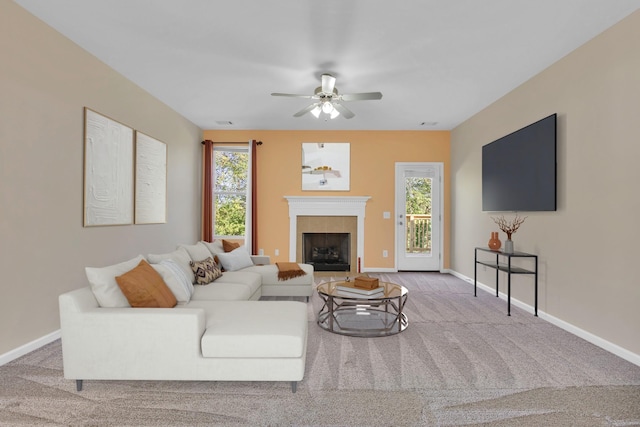 carpeted living room with ceiling fan and a healthy amount of sunlight