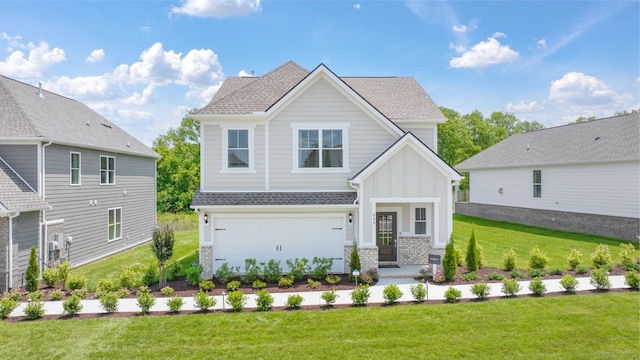 view of front of house featuring a front yard and a garage