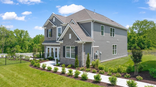 rear view of house featuring a yard