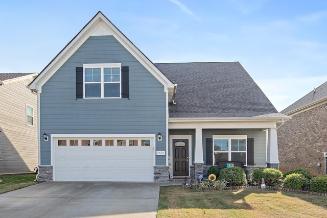 view of front of property with a front yard and a garage