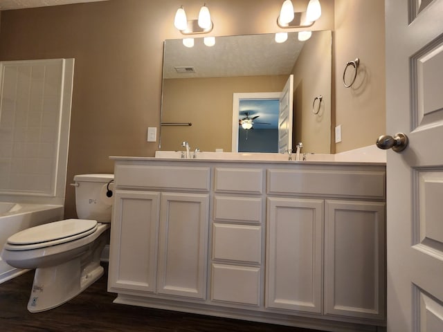 full bathroom with toilet, hardwood / wood-style floors, ceiling fan, bathtub / shower combination, and vanity