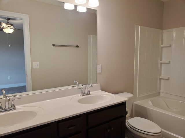 full bathroom featuring toilet, vanity, ceiling fan, and shower / washtub combination