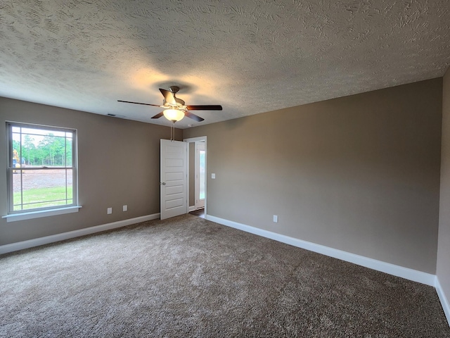 carpeted empty room featuring a textured ceiling and ceiling fan