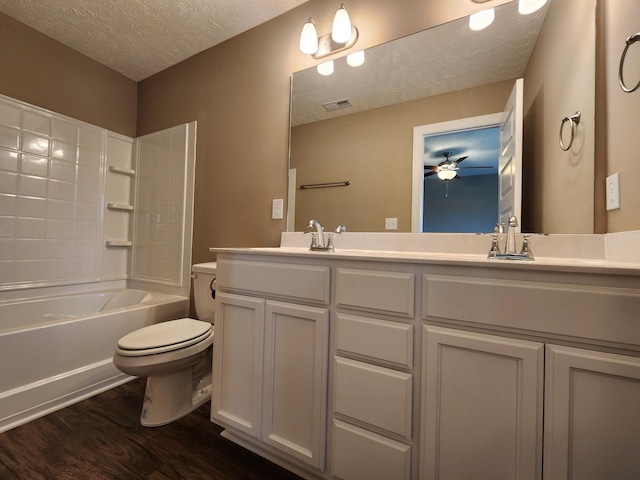 full bathroom with toilet, vanity, shower / washtub combination, wood-type flooring, and a textured ceiling