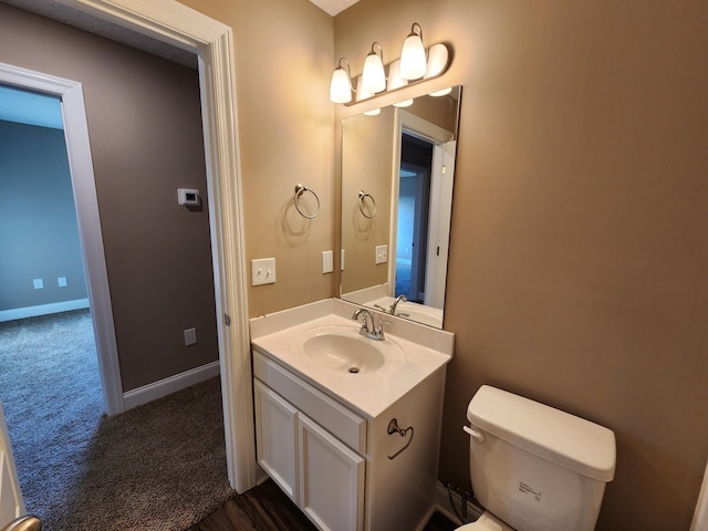 bathroom featuring toilet and vanity