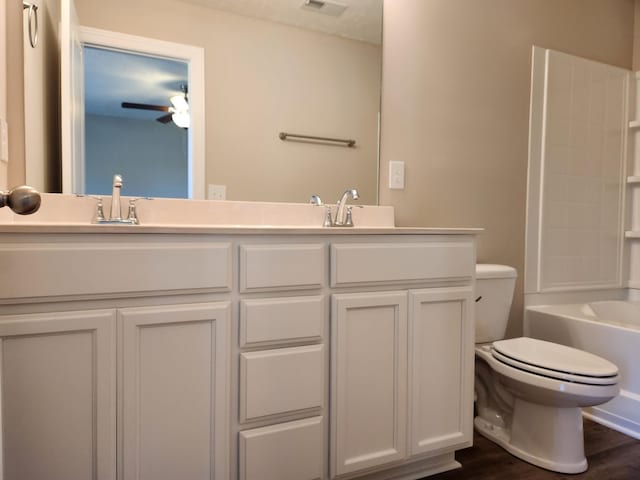 full bathroom with bathing tub / shower combination, vanity, ceiling fan, toilet, and hardwood / wood-style flooring