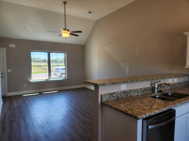 kitchen with lofted ceiling, white cabinetry, sink, stone countertops, and stainless steel dishwasher