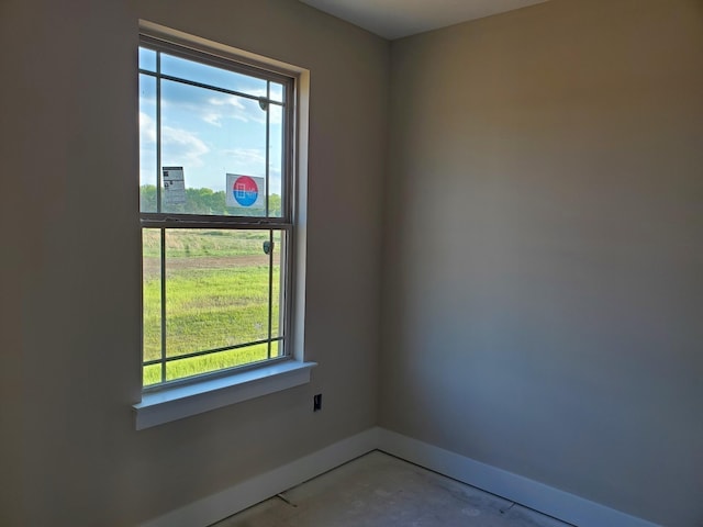 unfurnished room featuring concrete floors and plenty of natural light