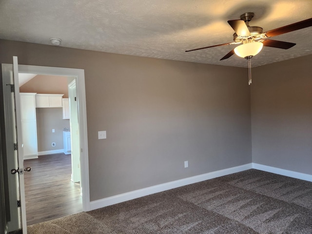 carpeted empty room with ceiling fan and a textured ceiling