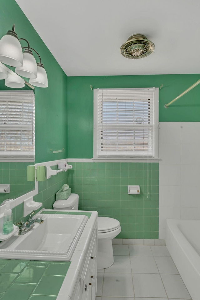 full bathroom featuring vanity, shower / tub combination, tile patterned flooring, toilet, and tile walls