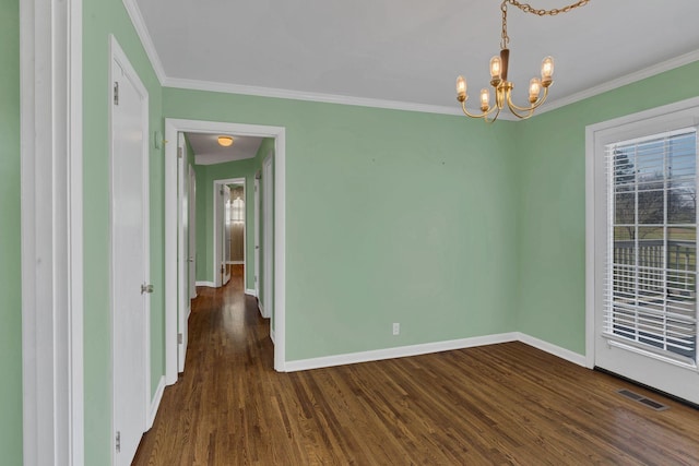 spare room featuring crown molding, dark hardwood / wood-style flooring, and a chandelier