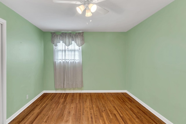 spare room with hardwood / wood-style flooring and ceiling fan