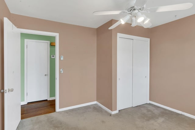 unfurnished bedroom featuring ceiling fan, light colored carpet, and a closet