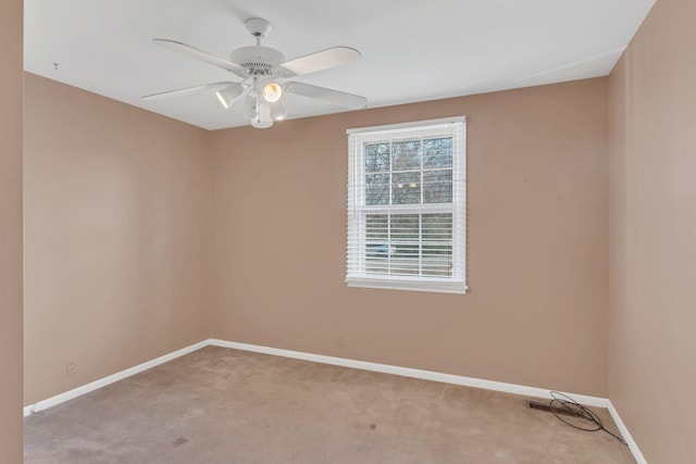 carpeted spare room featuring ceiling fan