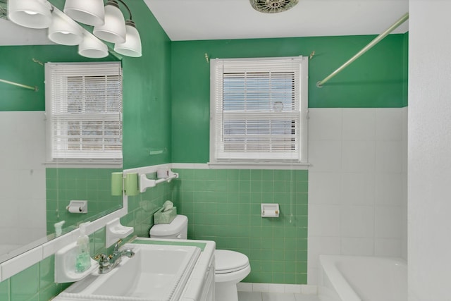 full bathroom featuring vanity,  shower combination, tile patterned flooring, toilet, and tile walls