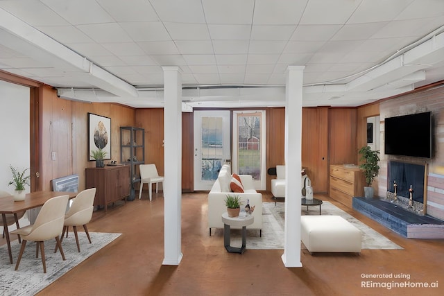4112 Marydale Dr, Nashville, TN 37207 - living room with finished concrete floors, wood walls, and a fireplace