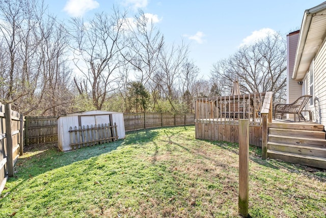 view of yard featuring a shed and a deck