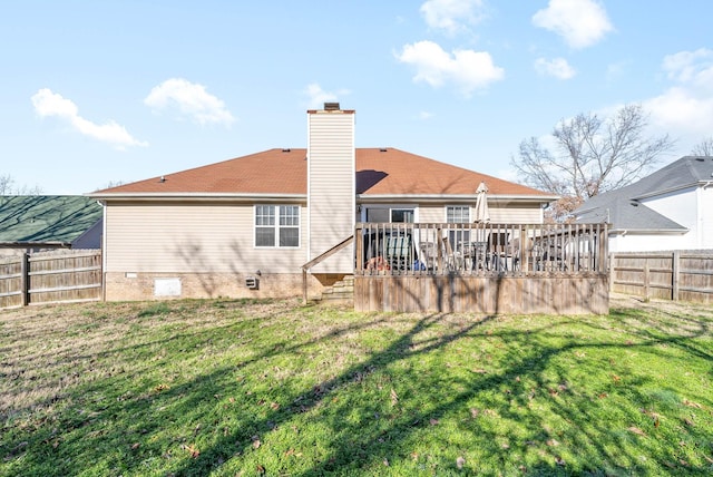 back of property featuring a deck and a yard