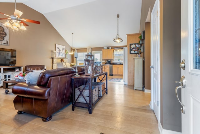 living room featuring ceiling fan, vaulted ceiling, and light hardwood / wood-style flooring