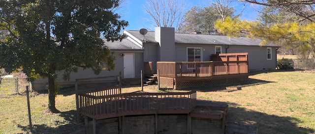 back of house with fence, crawl space, a lawn, a wooden deck, and a chimney