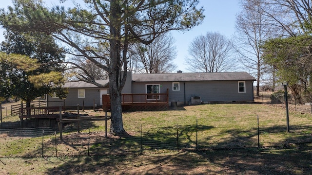 rear view of property featuring a deck, a yard, crawl space, and fence