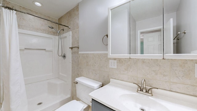 full bathroom with toilet, curtained shower, vanity, and tile walls