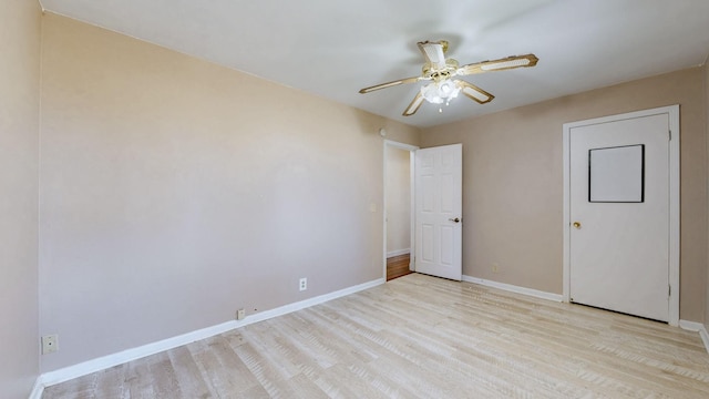 unfurnished bedroom with ceiling fan, baseboards, and wood finished floors