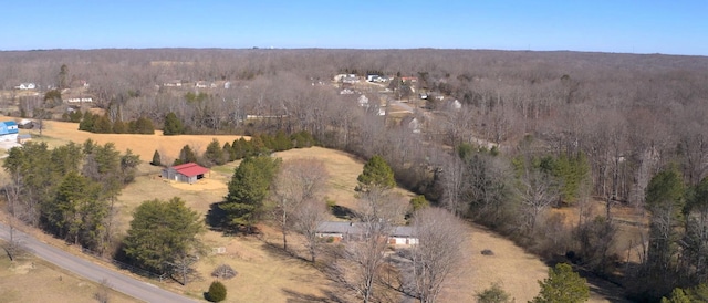 birds eye view of property featuring a rural view and a view of trees