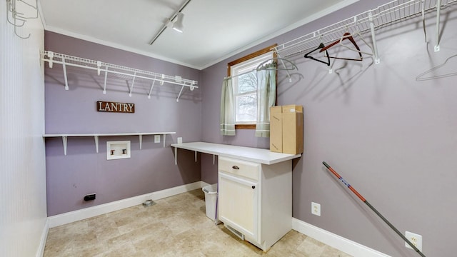 washroom featuring rail lighting, baseboards, and washer hookup