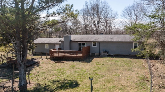 back of property featuring crawl space, a lawn, a wooden deck, and fence