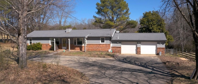 single story home with driveway, a garage, fence, and brick siding